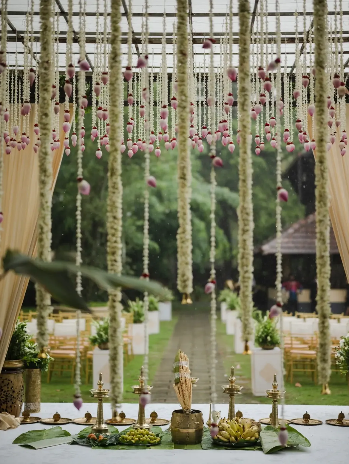 Outdoor floral pathway with lotus buds and scenic wedding photography backdrop
